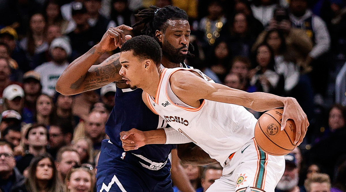 Spurs’ Victor Wembanyama backs down Nuggets’ DeAndre Jordan.